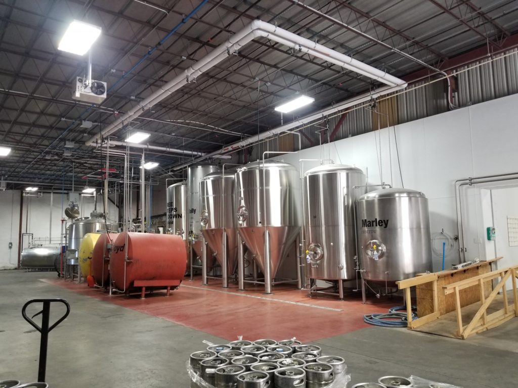 The brewery room is filed with several large, chrome vats, presumably filled with a variety of brews.