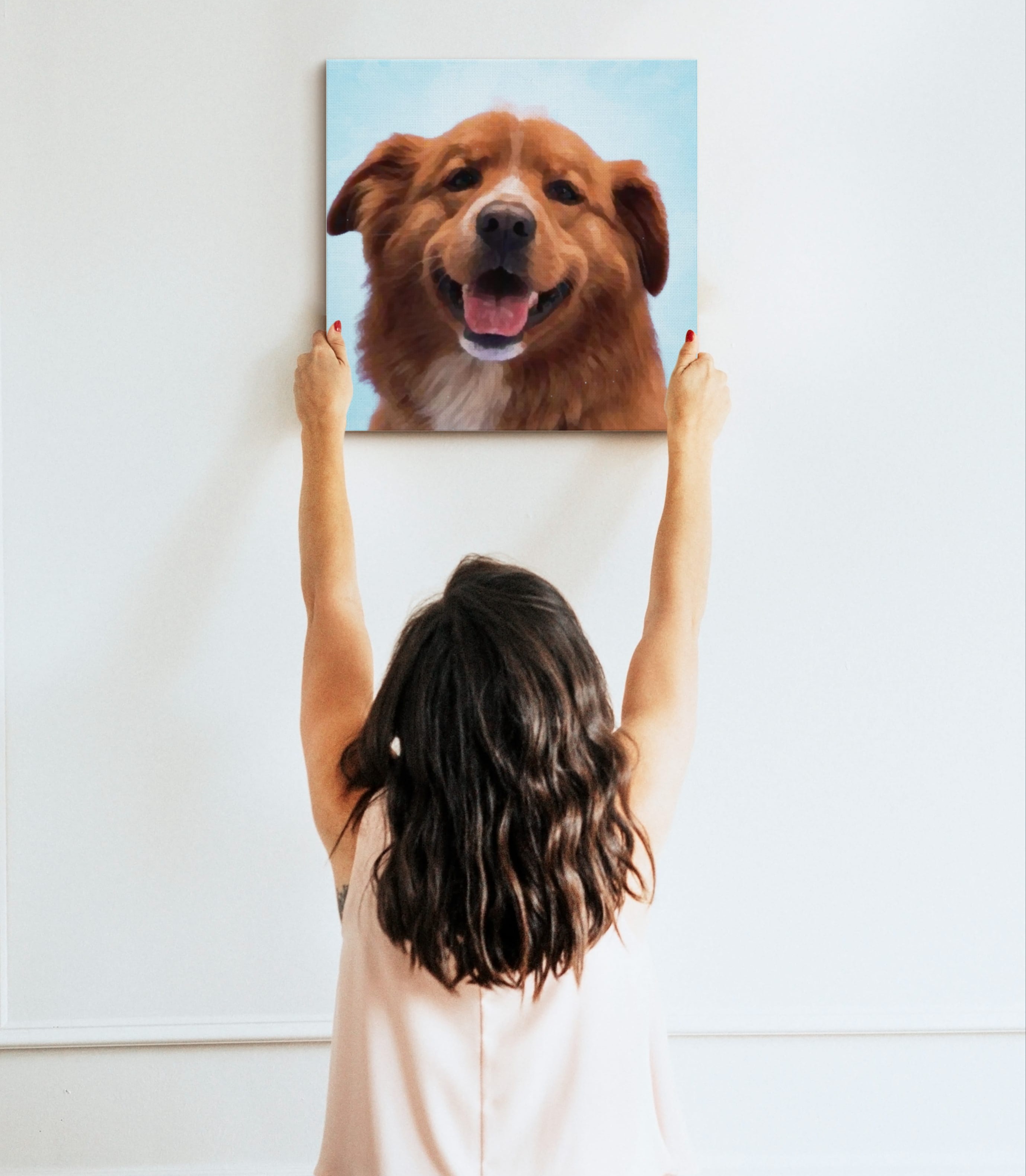 Photo of woman hanging pet portrait on the wall