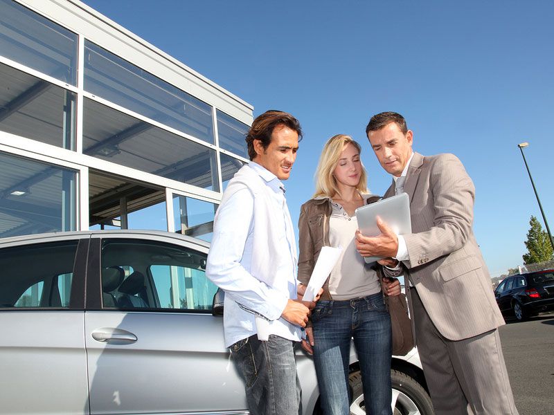 bigstock Car salesman with couple outside of car dealer ・  Photo by Bigstock 