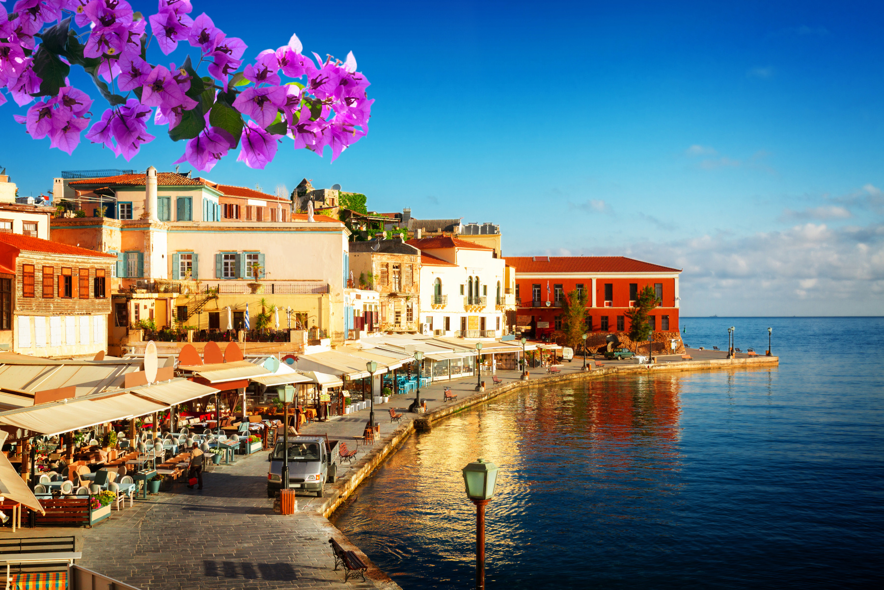 the harbour of Chania in Crete Greece with the image of a bugambilia branch on the front
