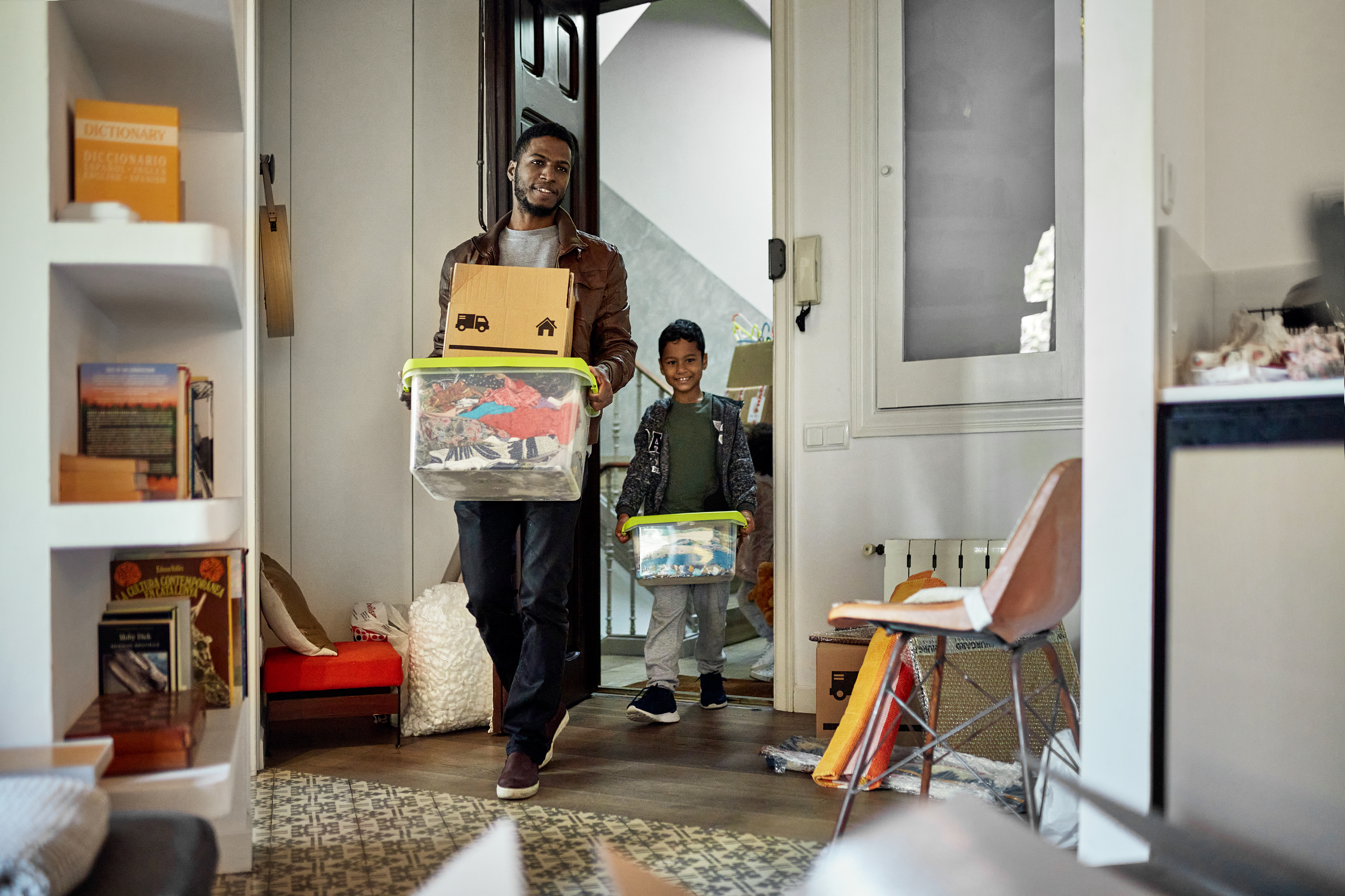 Young Boy Following Father into New Apartment on Moving Day