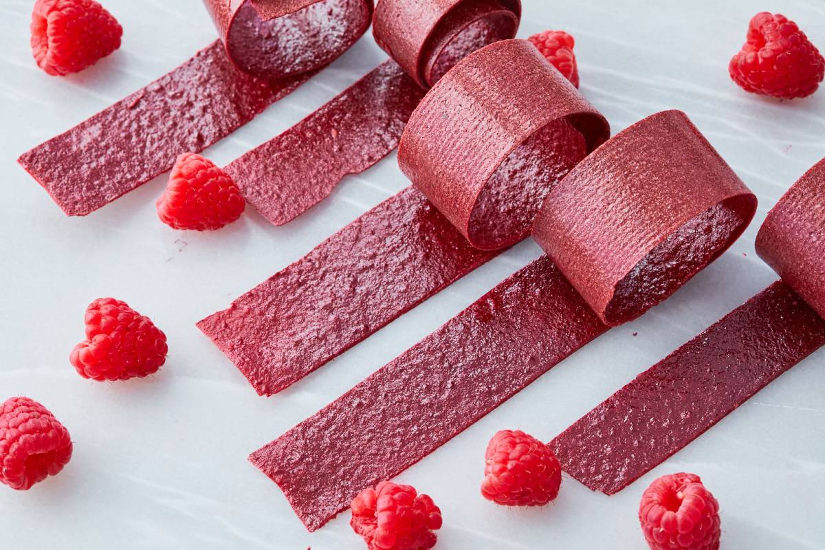 Raspberries and rolled-up strips of fruit leather, some of the best camping snacks