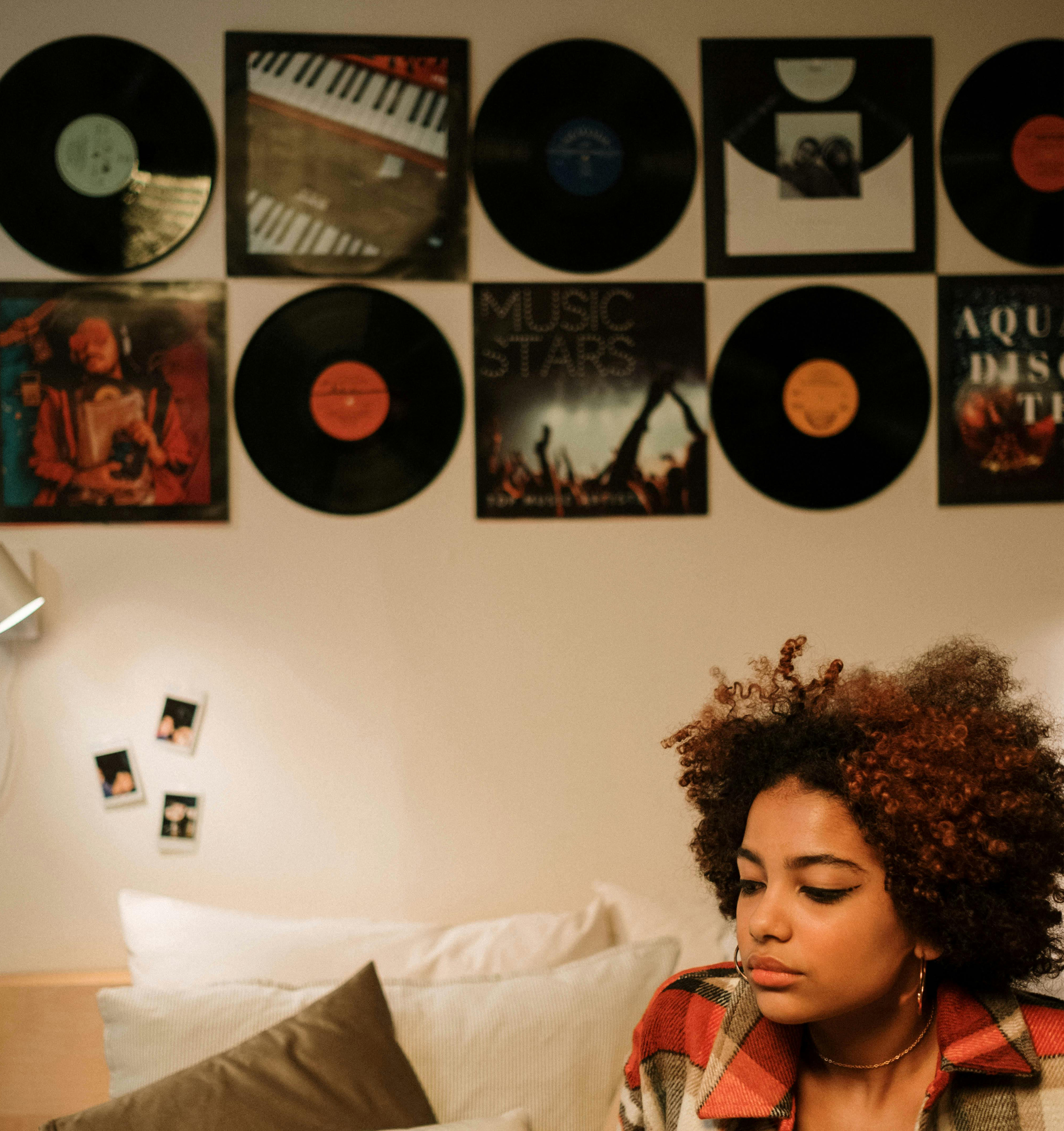 girl with music record wall art in the background