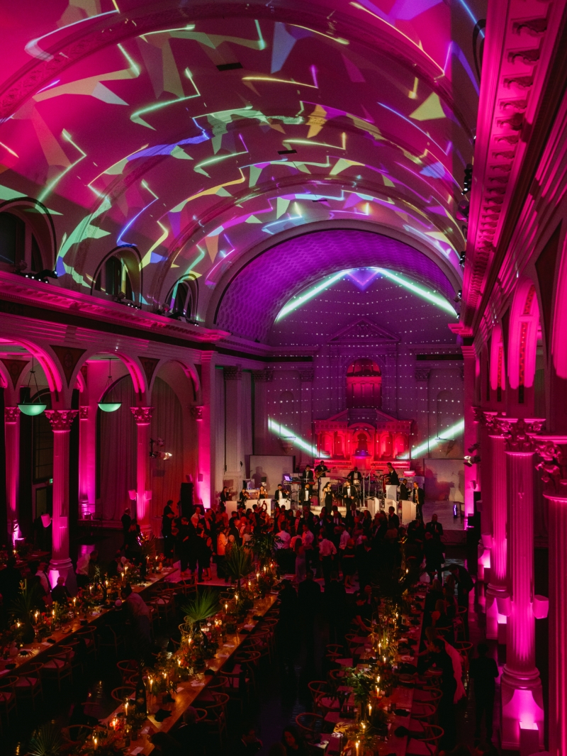 a band performs in front of a crowd at a colorful cathedral wedding reception in downtown Los Angeles