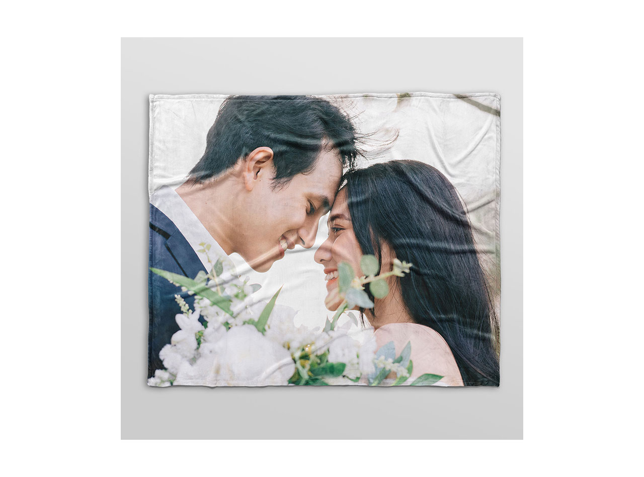 A custom fleece blanket featuring a photo of happy couple on their wedding day. 