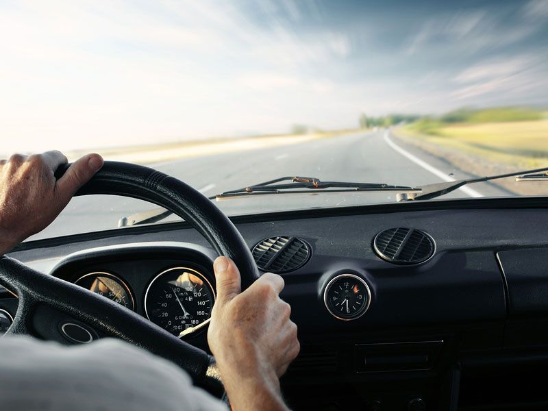 Driver s hands on a steering wheels 