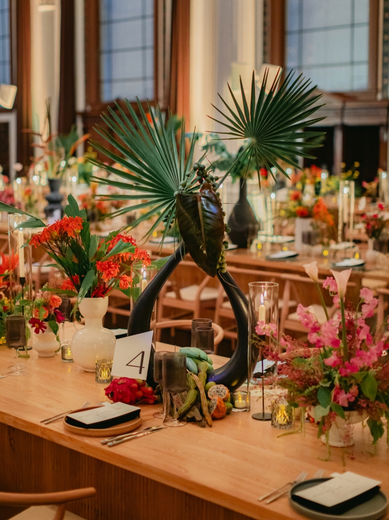 close up of florals in vases on wooden tables in a downtown Los Angeles cathedral wedding reception