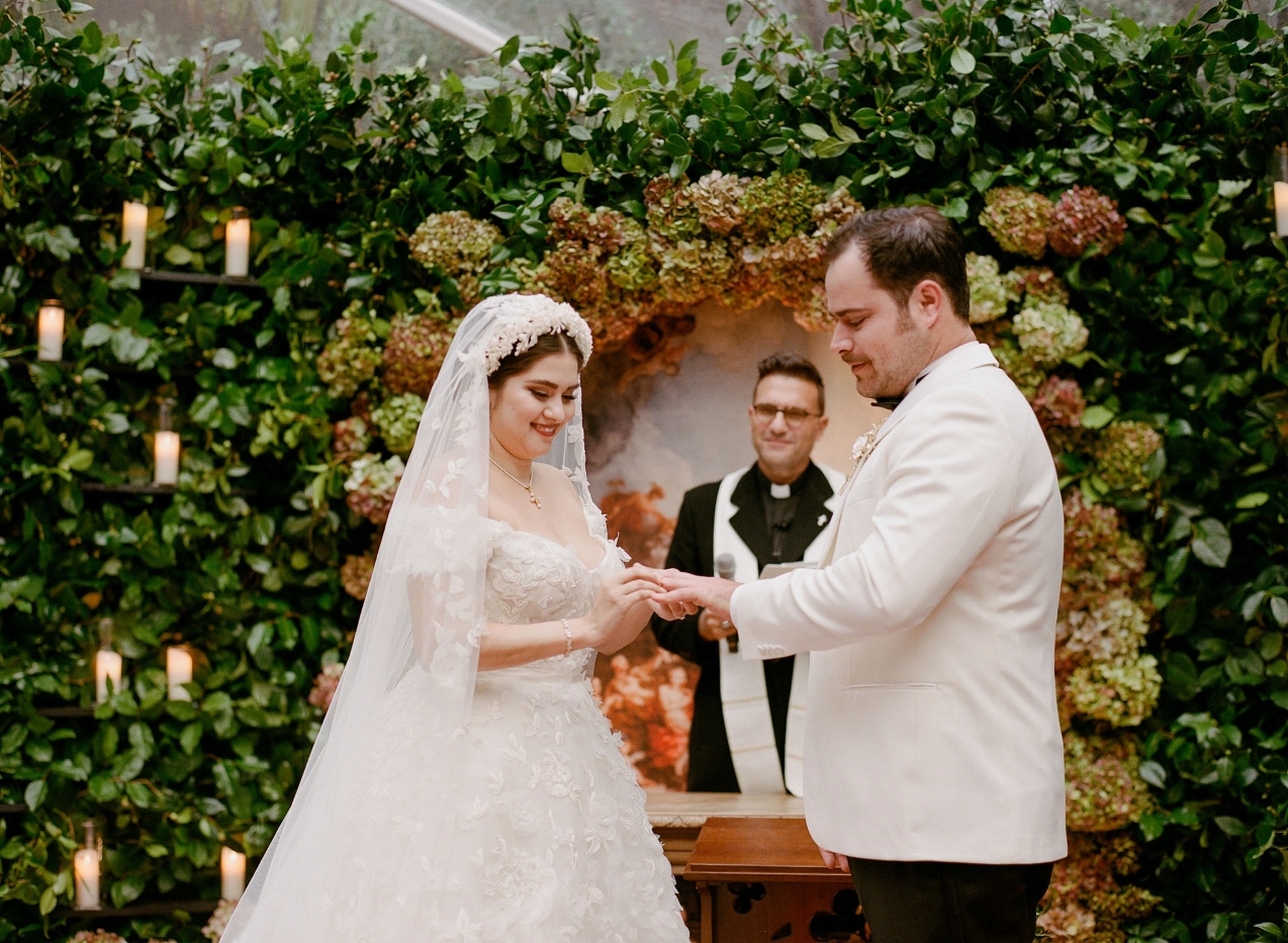 a groom presents his bride with her ring at a DTLA outdoor courtyard wedding ceremony