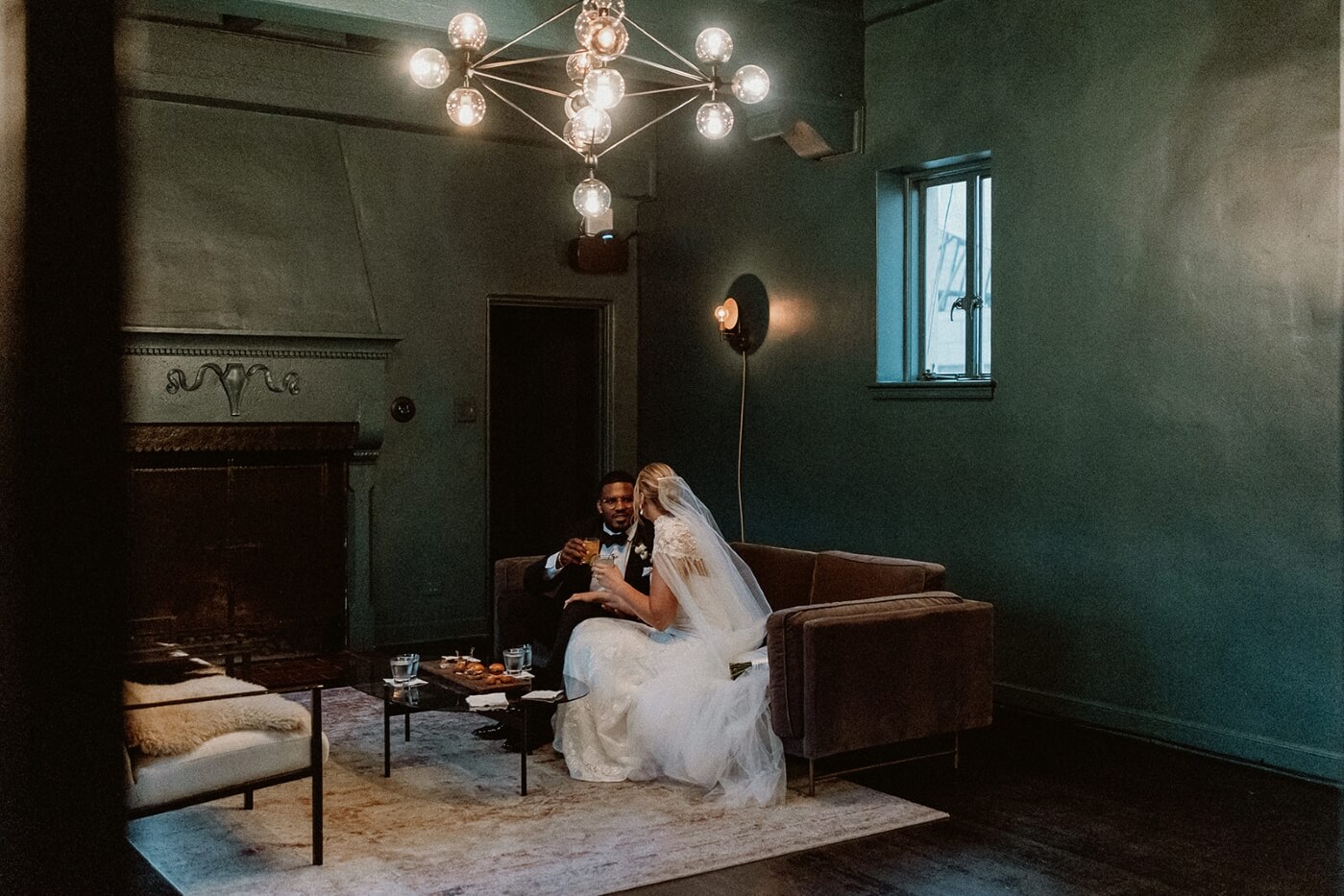 bride and groom sitting on couch