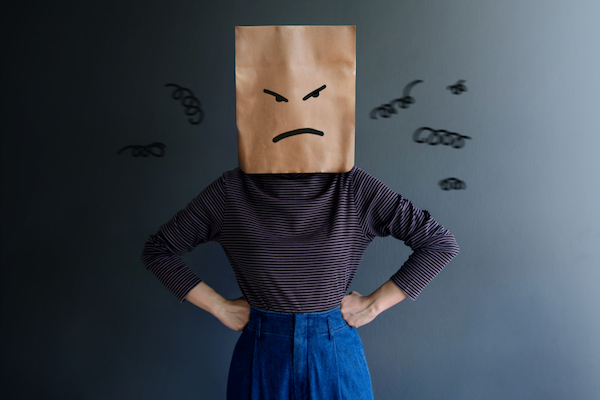 woman with paper bag over her head with frowny face for fake reviews