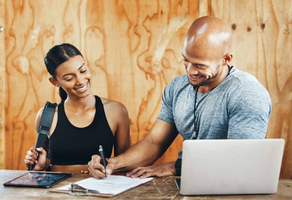 gym owner going over memberships with female client