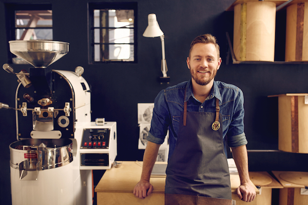 small business owner with coffee roasting equipment