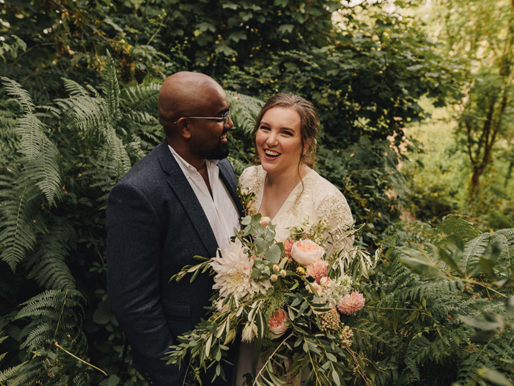 a narnia-like wedding, with bride and groom surrounded by foliage