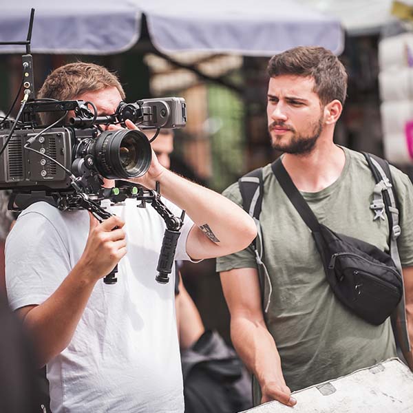 Camera man and production crew on a film set