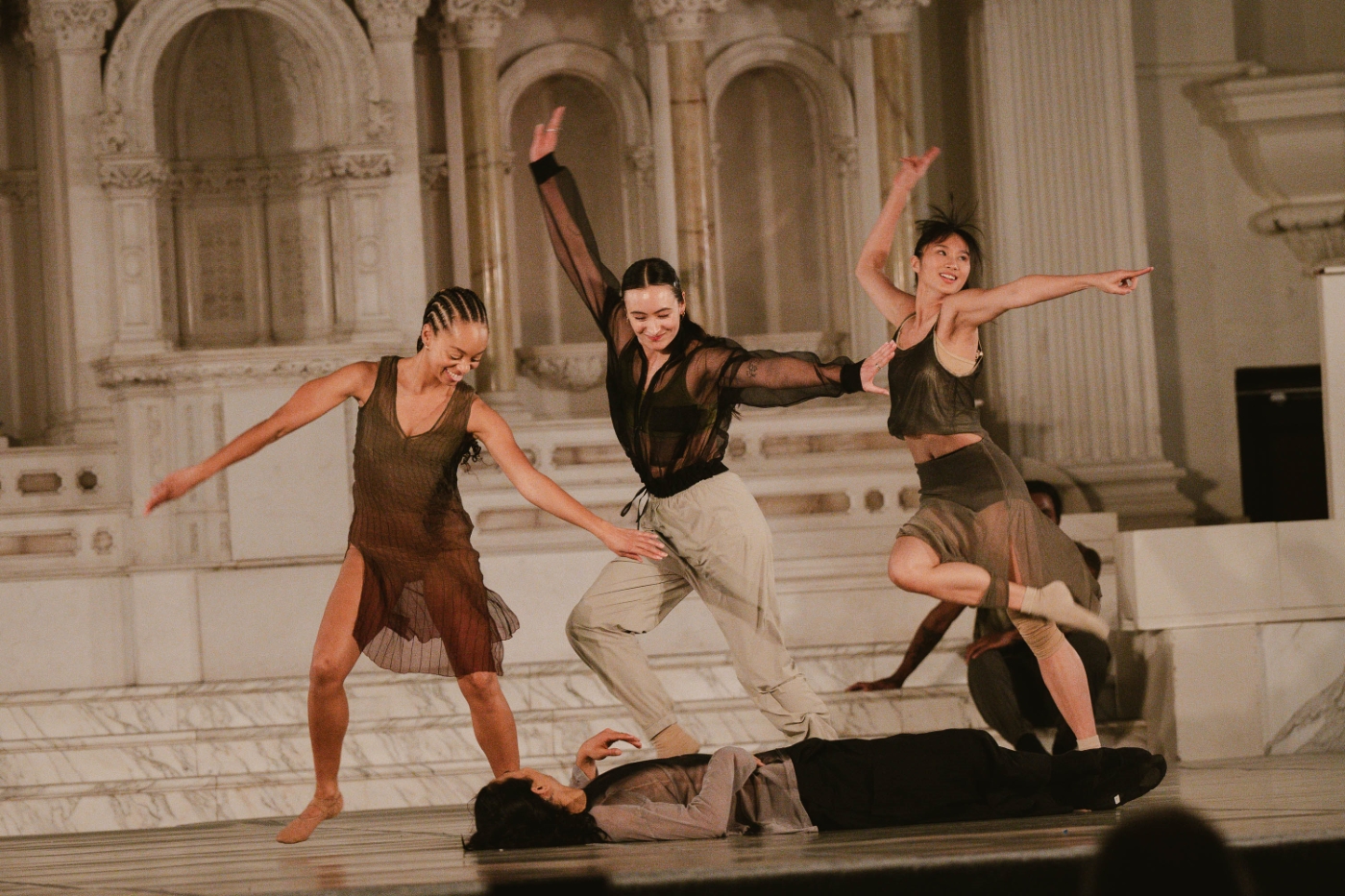 a group of dancers dressed in neutral colors dance over a fellow performer laying down beneath them at a dance gala at Vibiana in downtown Los Angeles