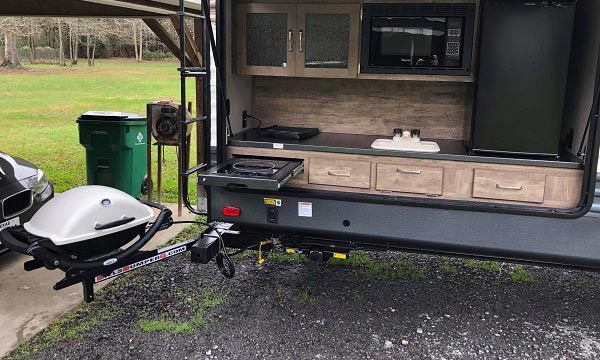 Outdoor RV grill mounted next to an outdoor kitchen