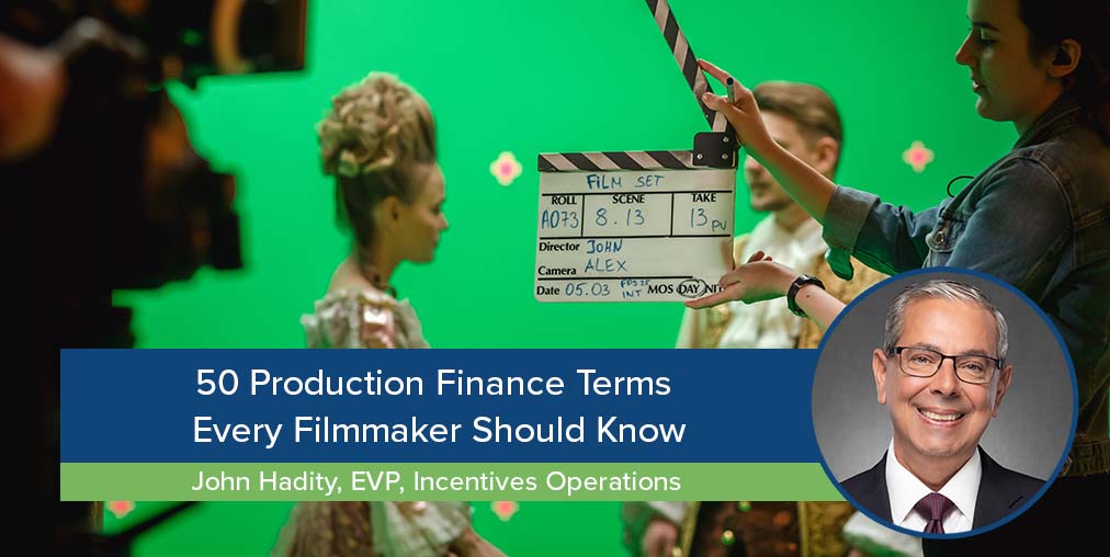 Blog title "50 Production Finance Terms Every Filmmaker Should Know" over the second assistant camera (2nd AC) and actors on a film set