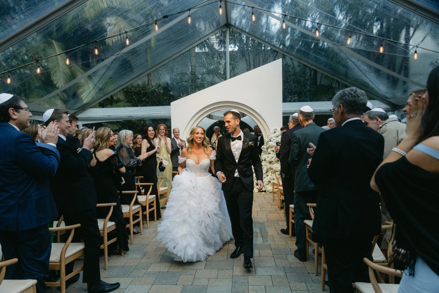 a bride and groom walk back down the aisle after their DTLA outdoor cathedral wedding ceremony