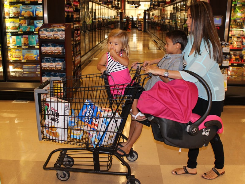 Car seat on store top of shopping cart