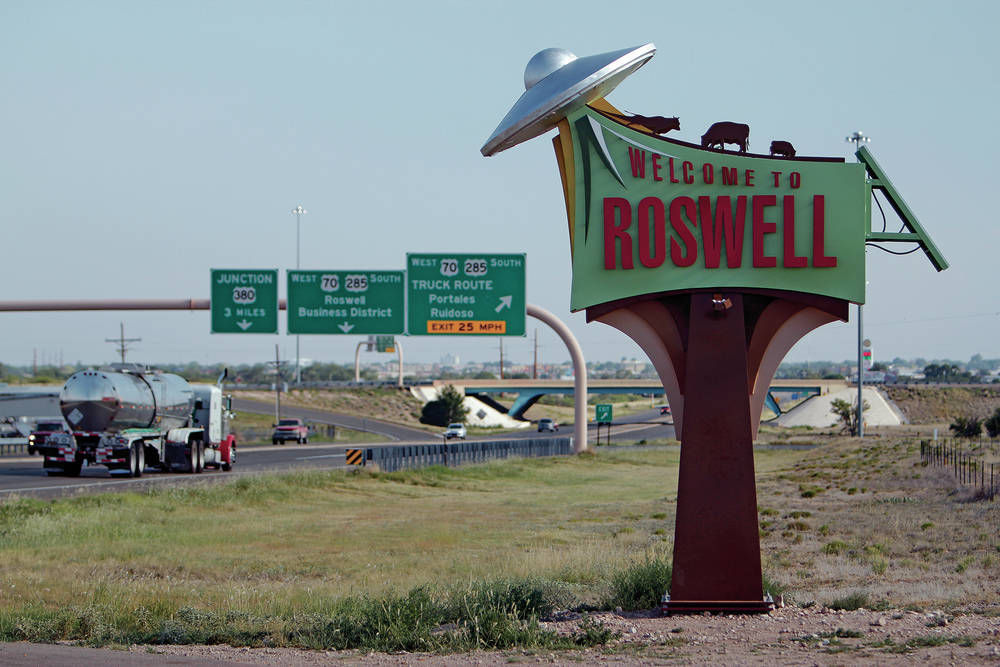 "Welcome to Roswell" sign with UFOs decorating it