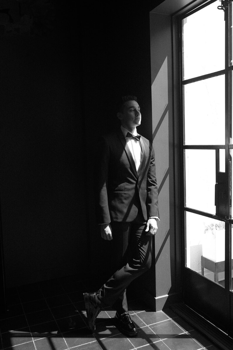 groom in front of window