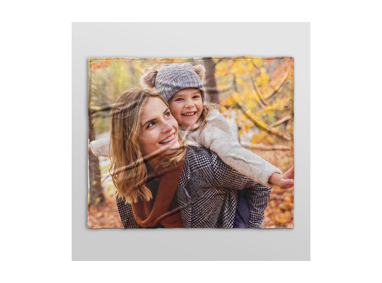 An image of smiling mother and daughter printed on a fleece blanket. 