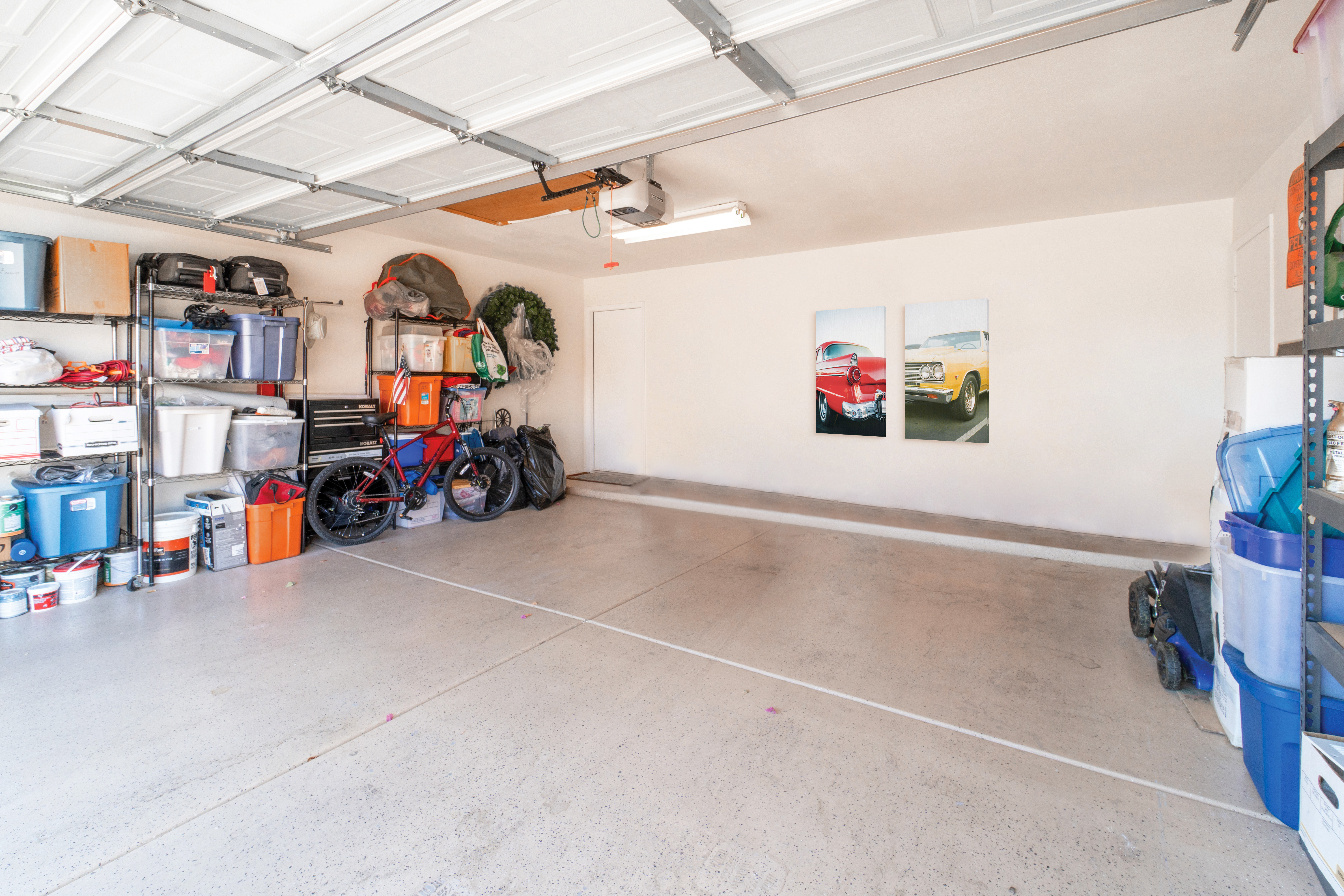 Two canvas prints of cars in garage