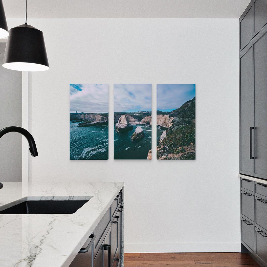 Triptych print in kitchen of mountains