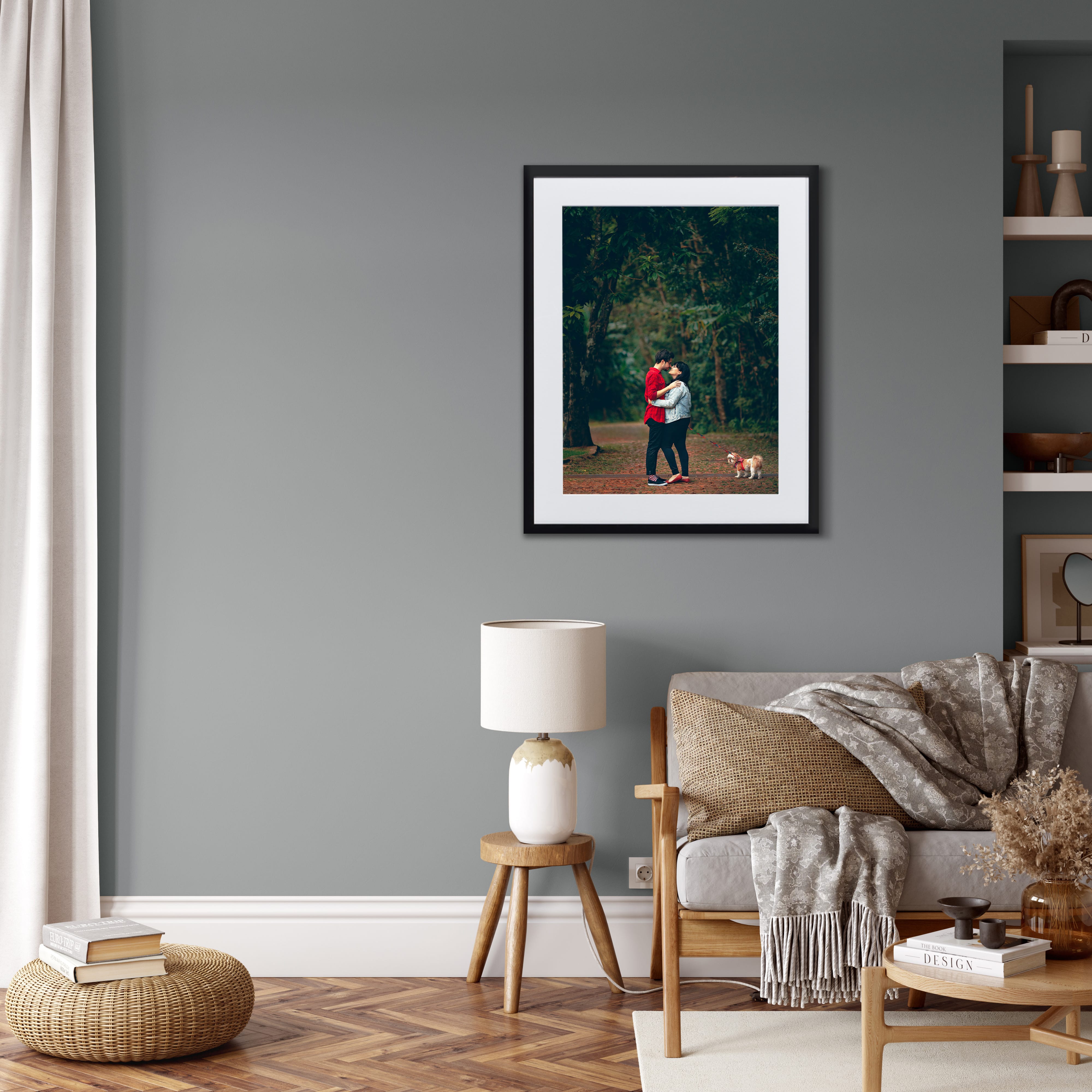 Framed print in living room of couple and their dog in the forrest