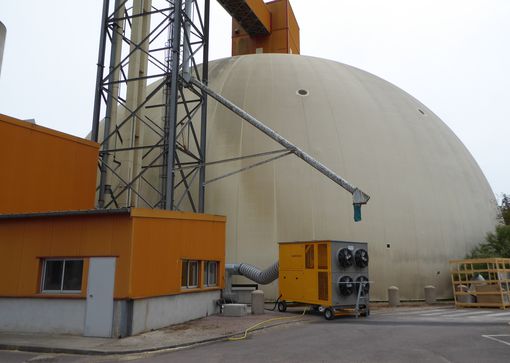 Grain cooling unit in front of round silo. Effective ventilation of grain.