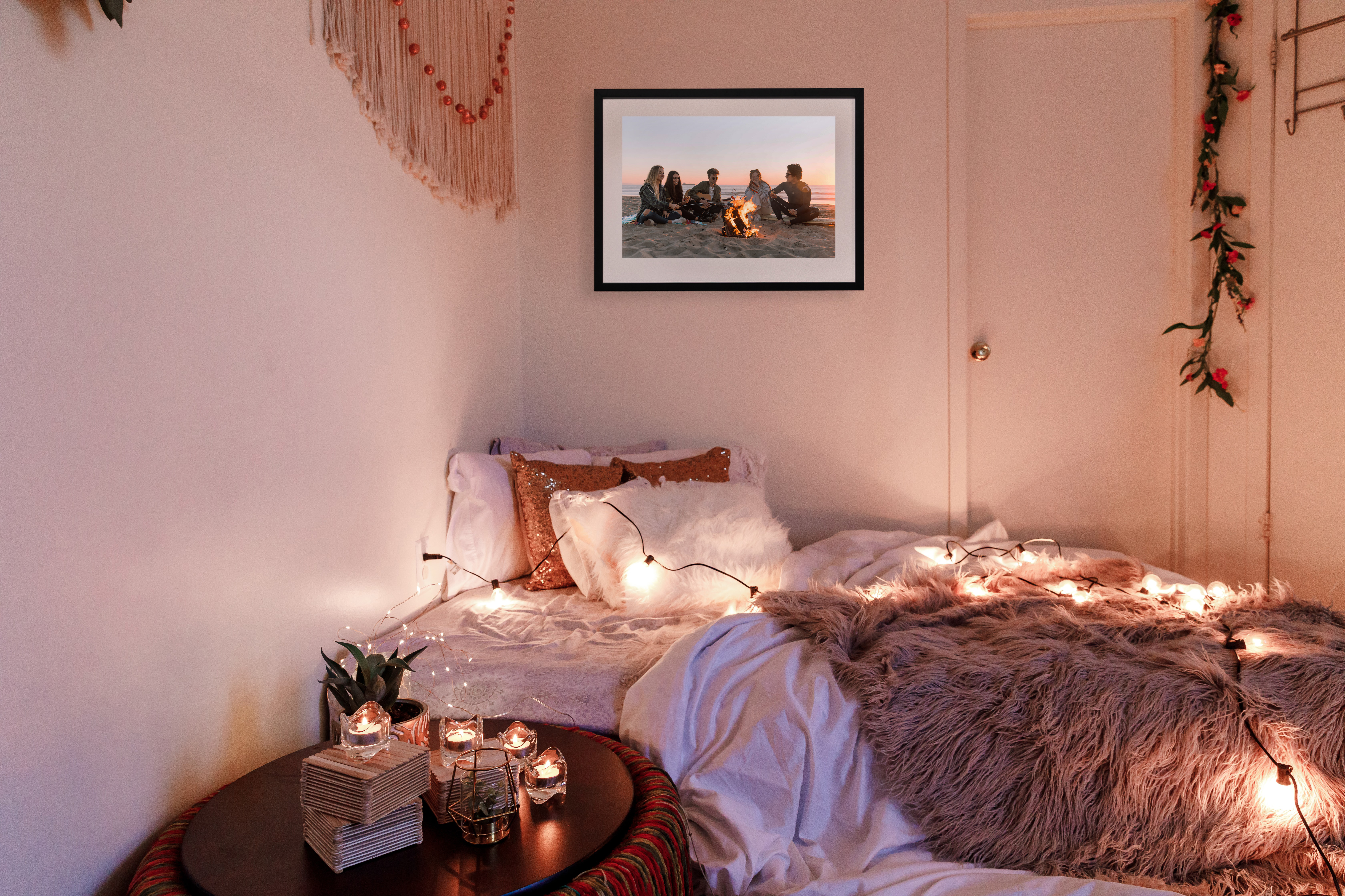 Framed print of friends at the beach in dorm room with fairy lights