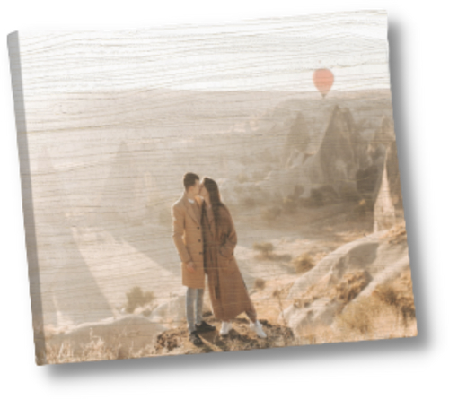 A couple kissing in front of a canyon printed on a wood