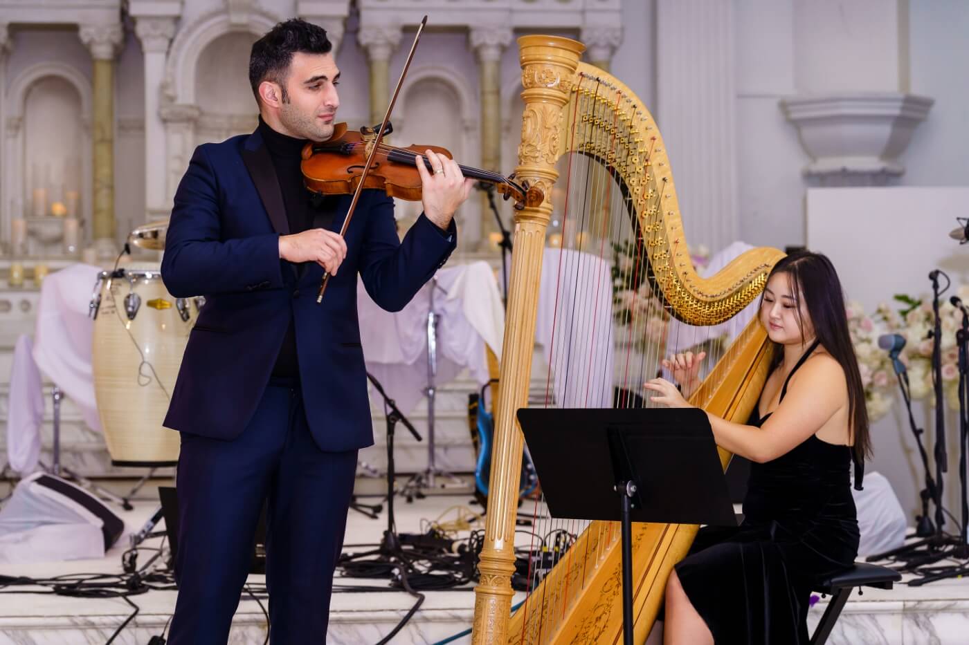violinist and harpist performing