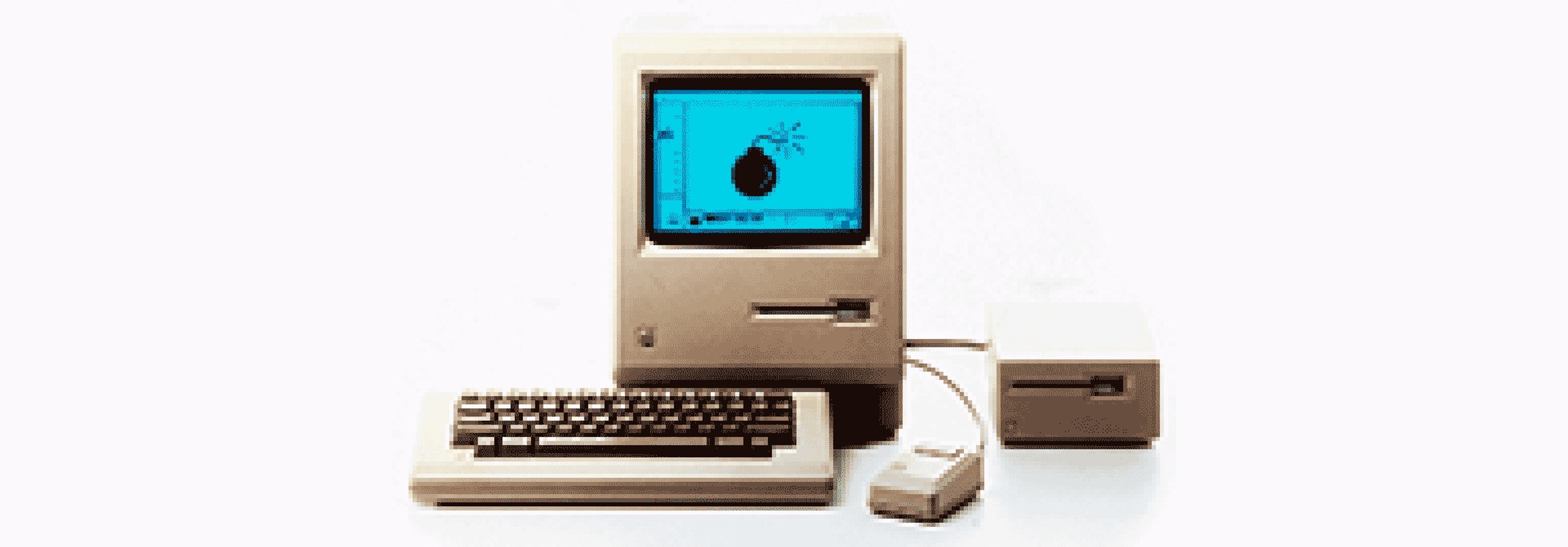 A 1984 Macintosh computer with mouse and floppy drive