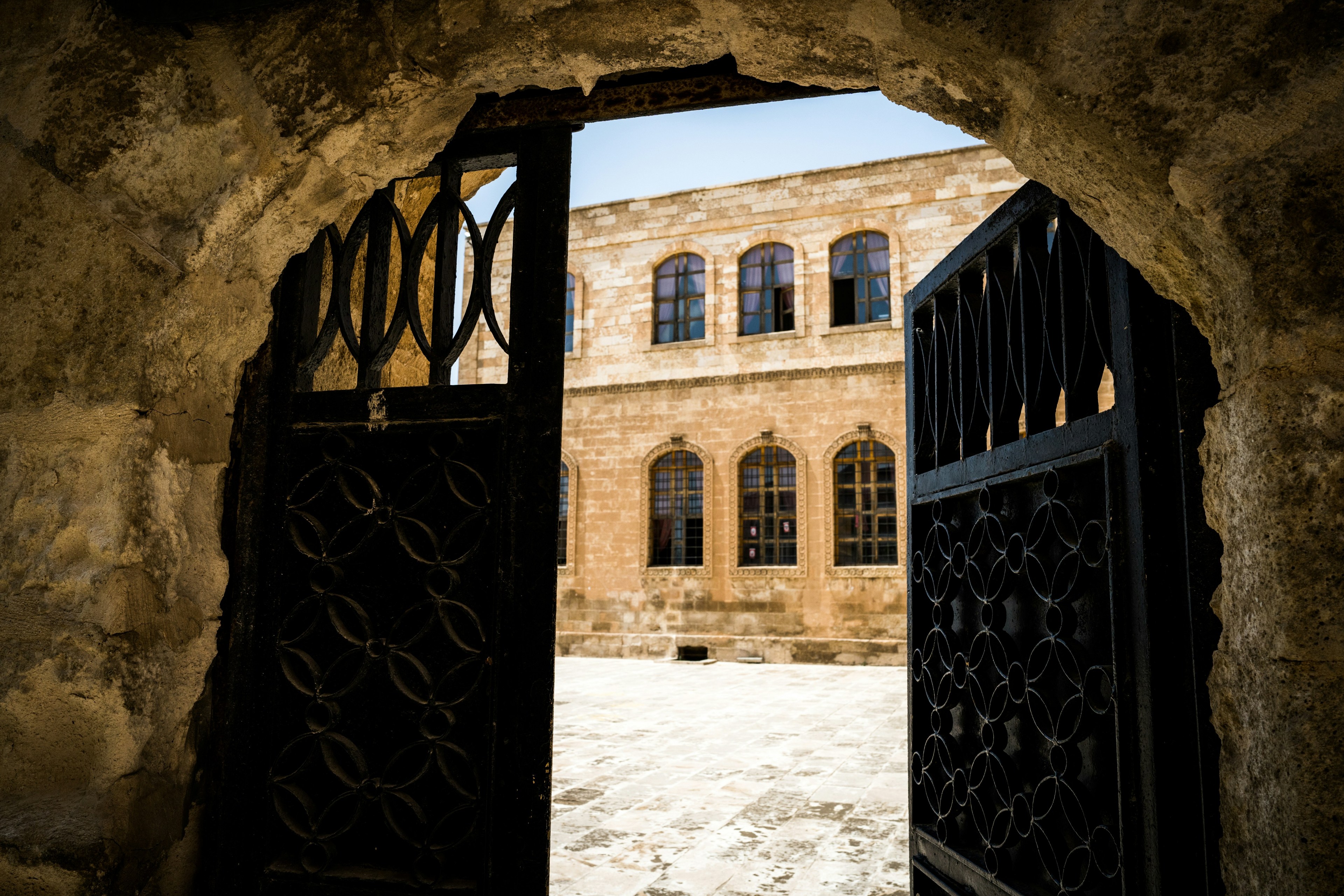 A castle-like building behind a half-open gate