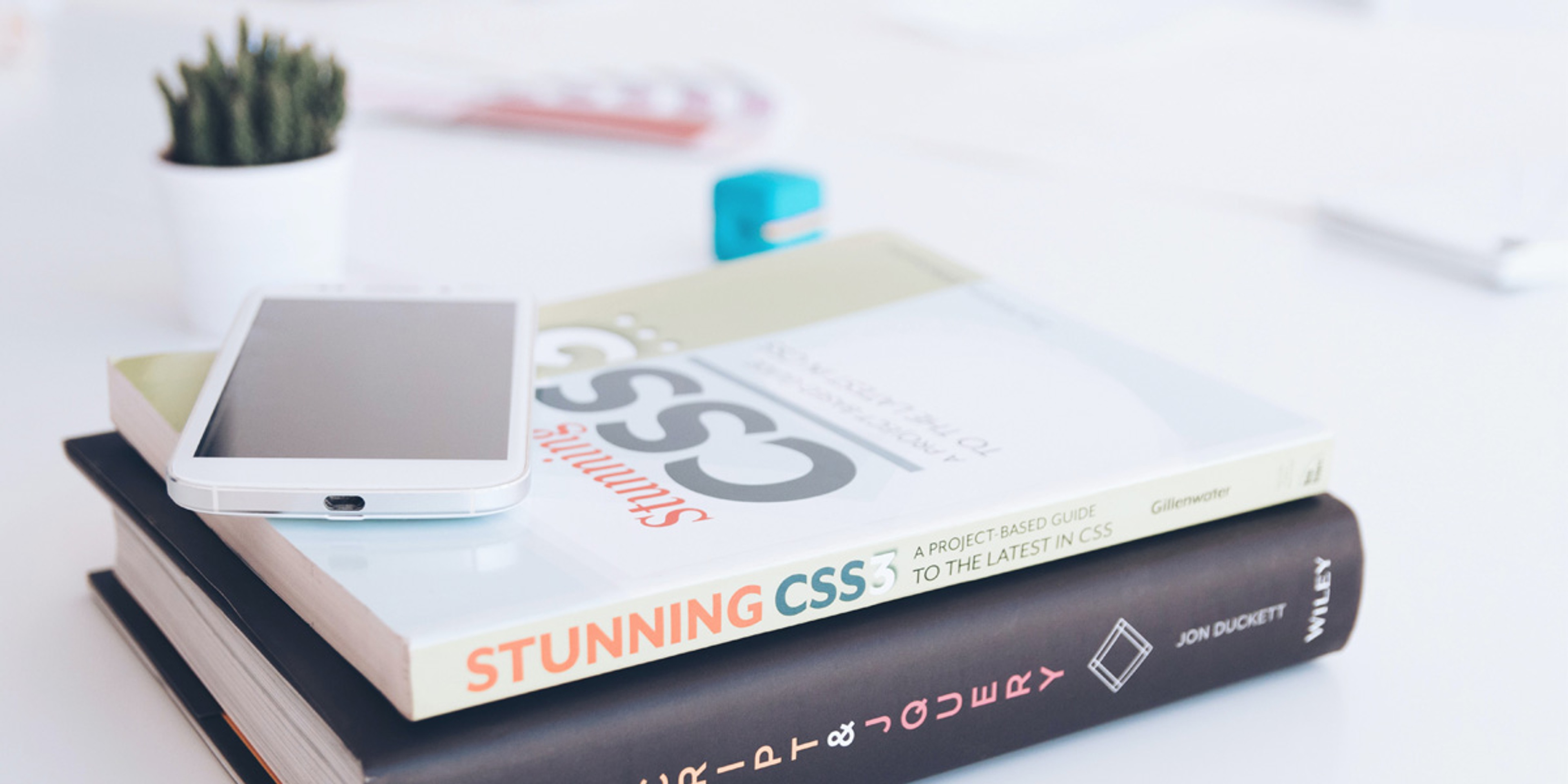 two books about css modules and a smartphone on top