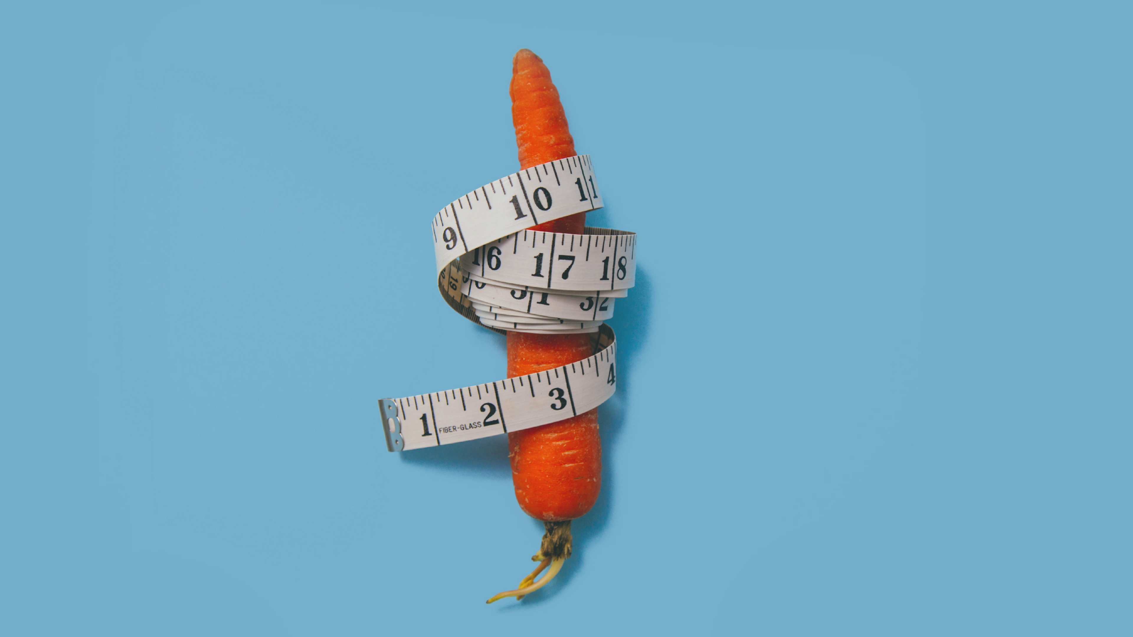 a carrot with a measuring tape wrapped around