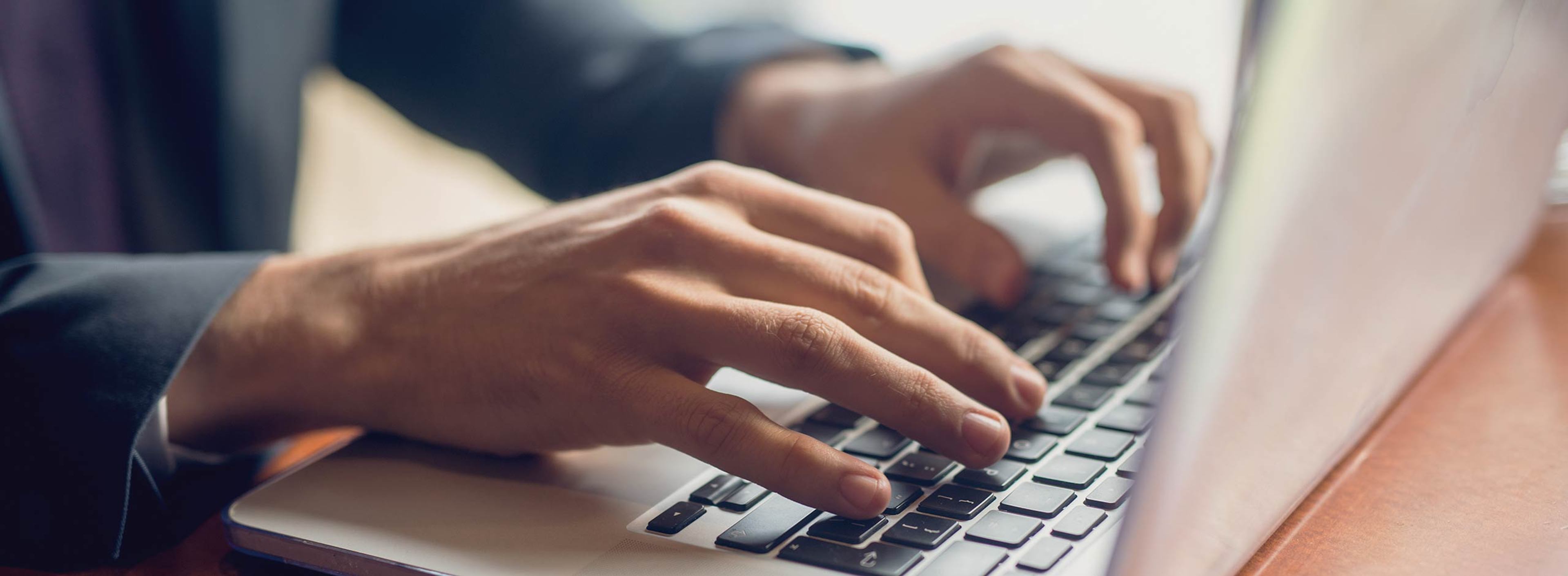 Closeup of hands writing an excercise in a typescript workshop