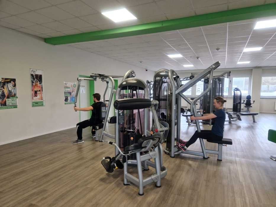 People train on fitness equipment
