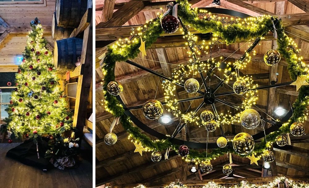 Weihnachtsdekoration vom BarrelHouse; links ein geschmückter Weihnachtsbaum und rechts eine festlich geschmückte, runde Lampe, die an der Decke hängt.