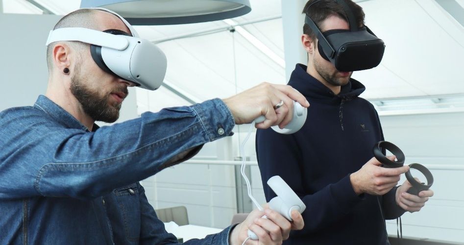 Two men operate VR glasses