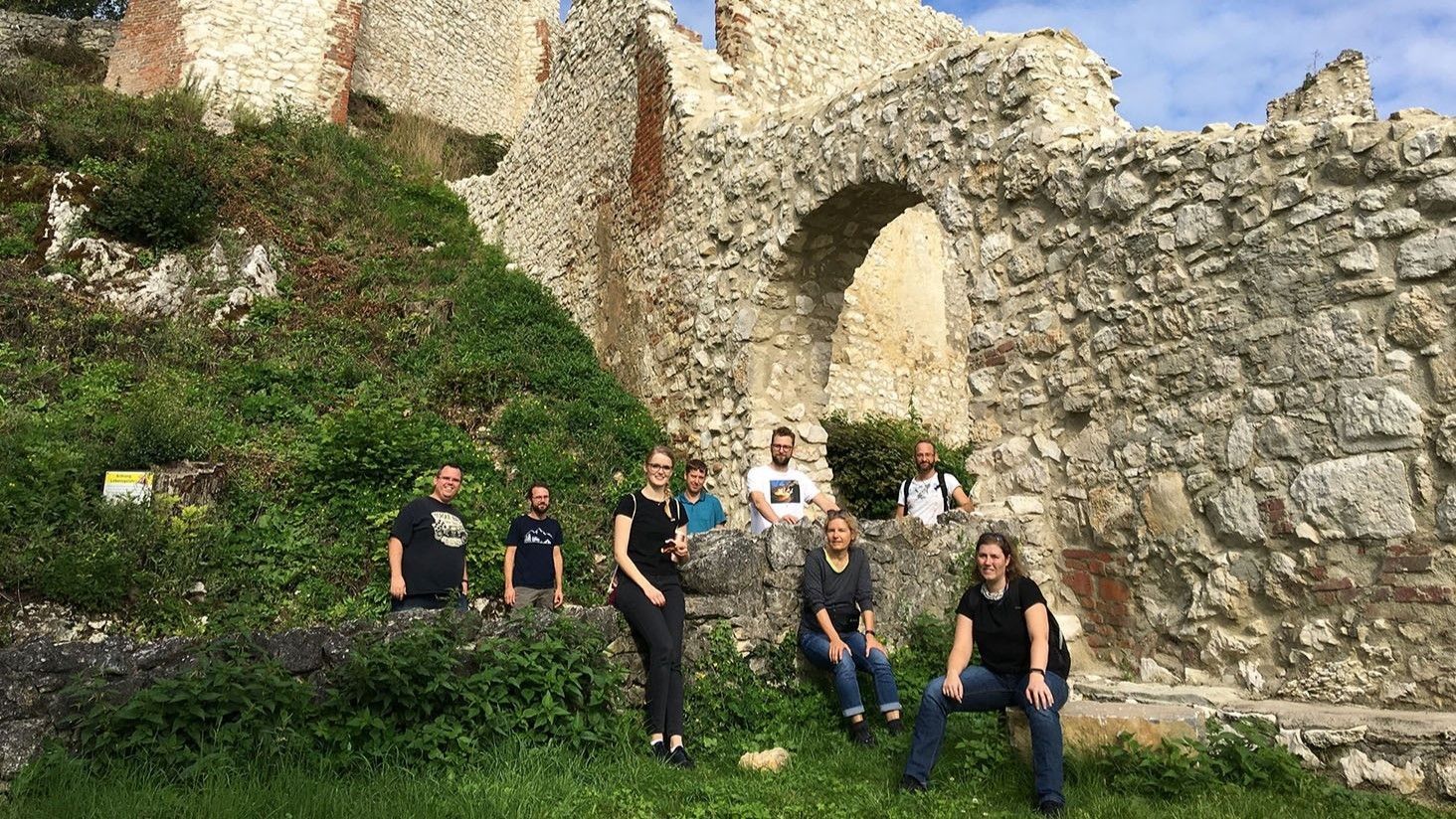 Team in front of a ruin