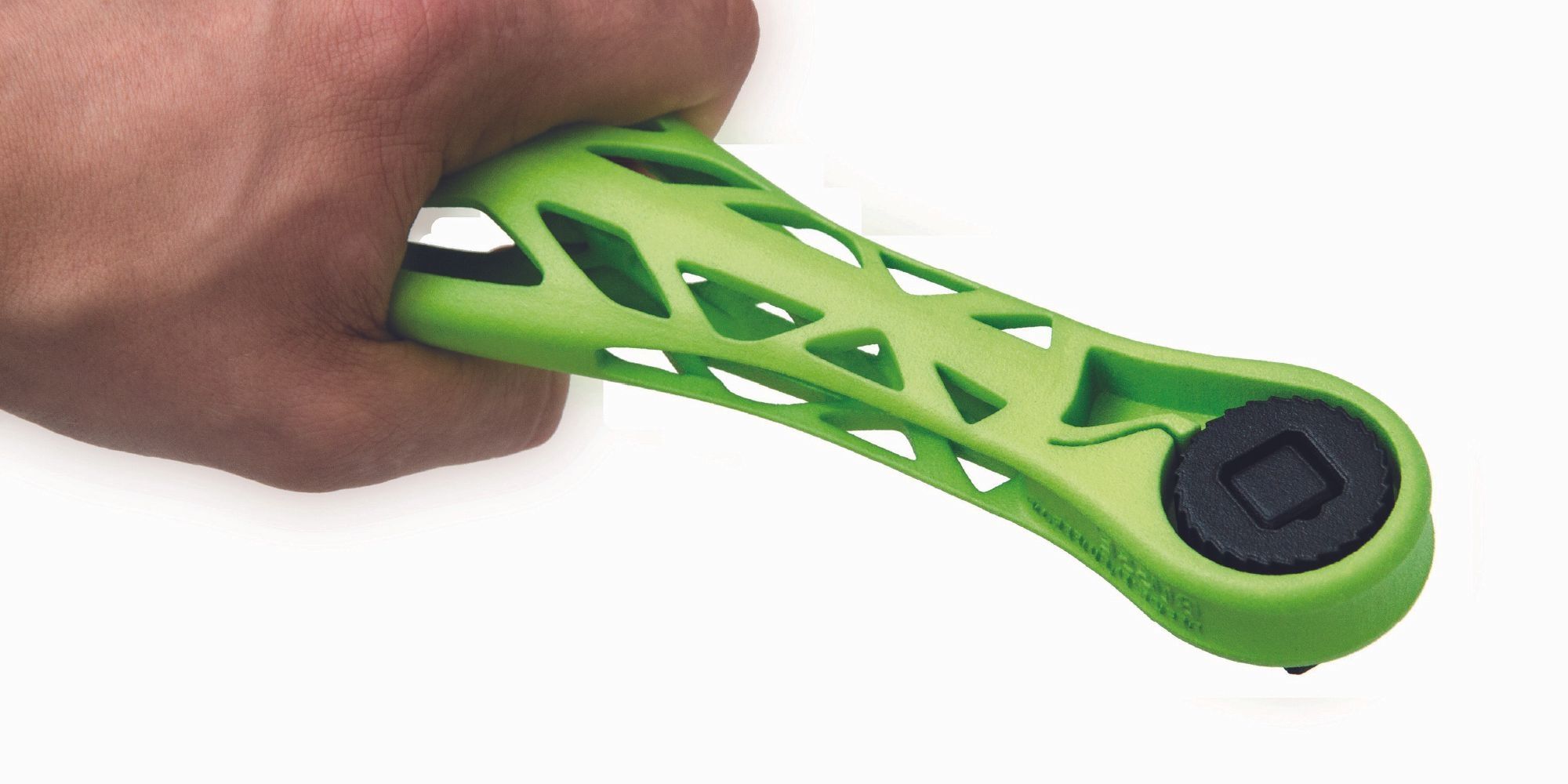 Hand holds a model of a green lightweight ratchet.