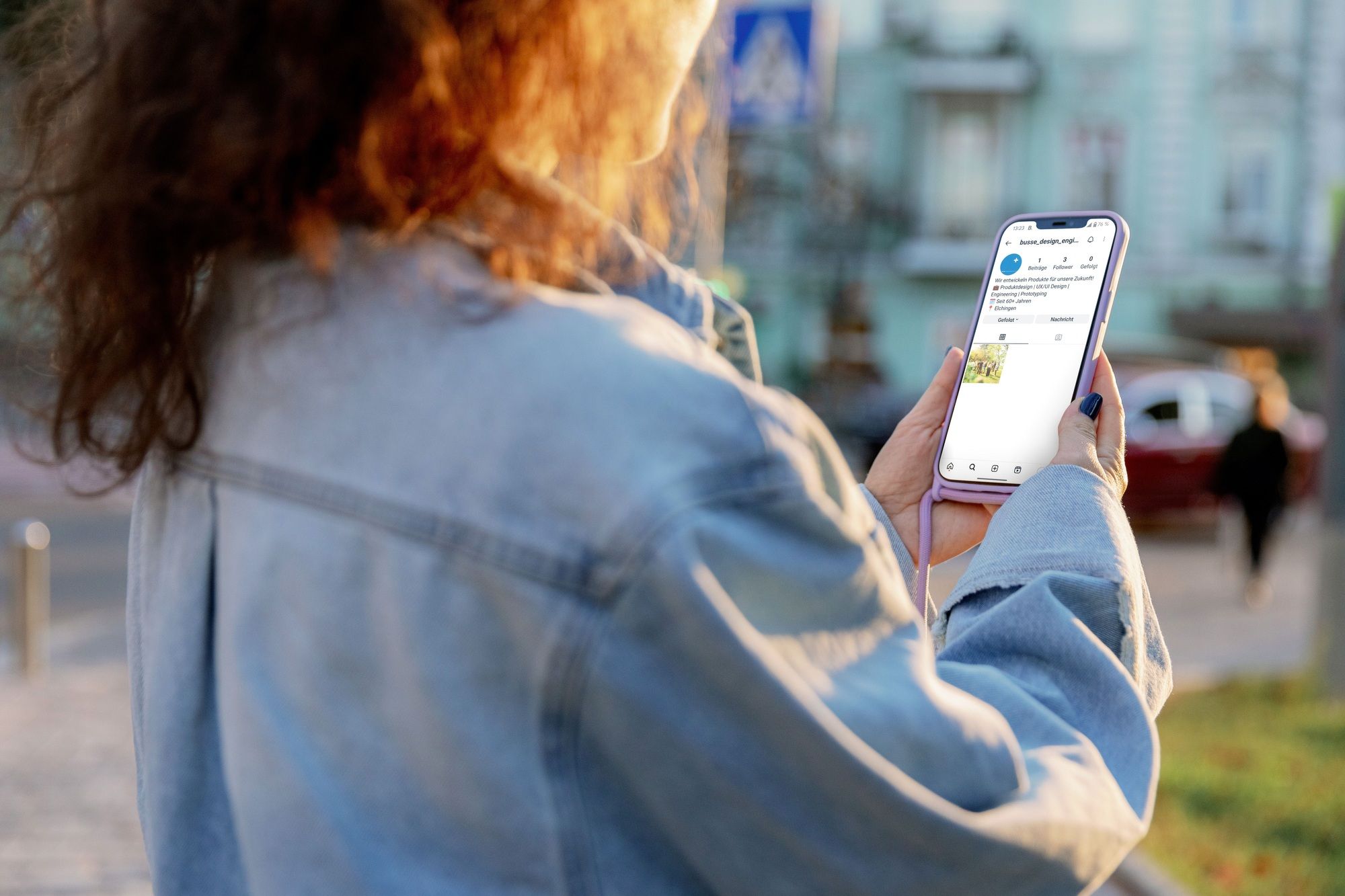 A woman looks at the BUSSE Instagram profile on her mobile phone.