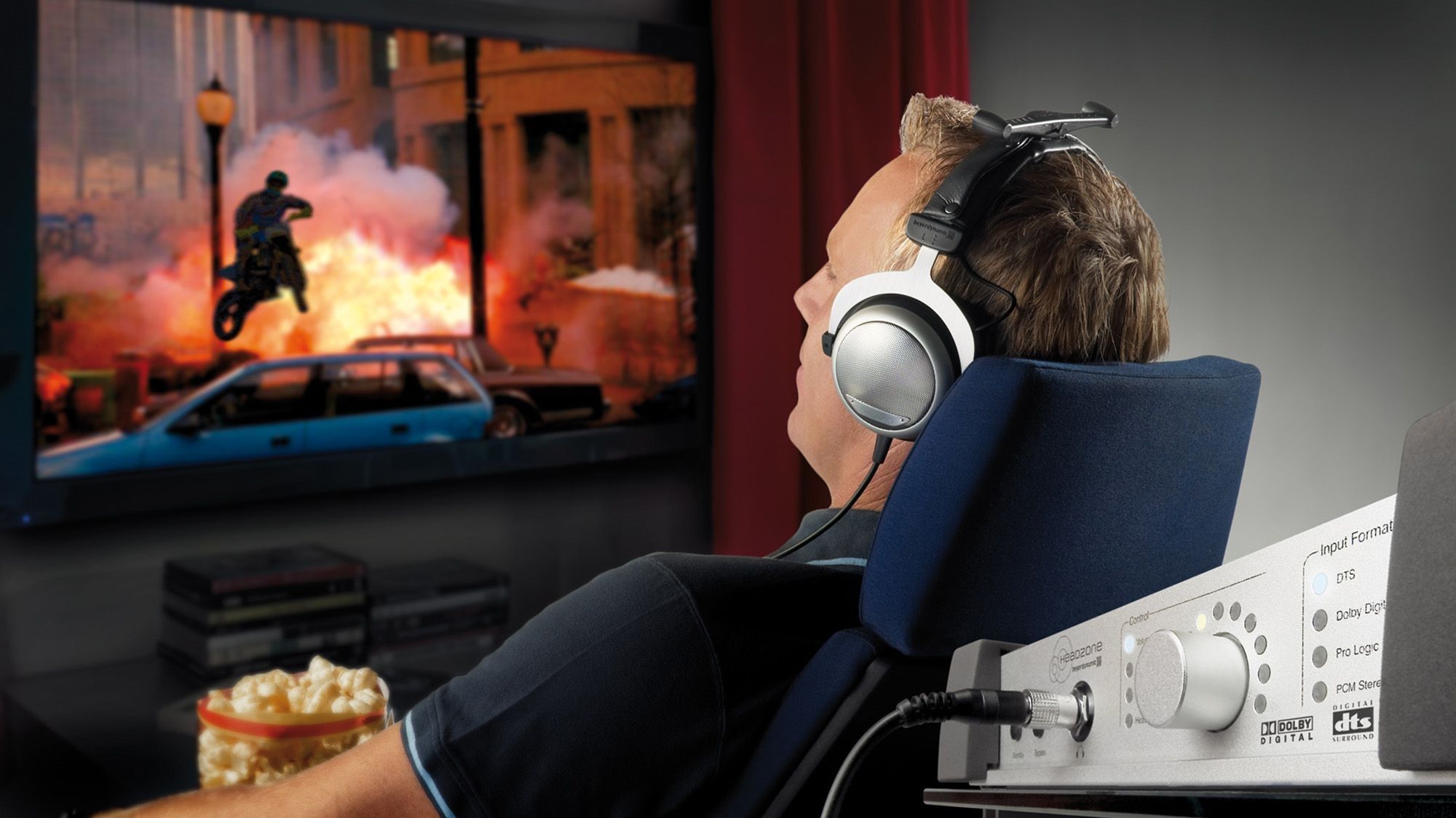 Man sitting in front of the TV with headphones