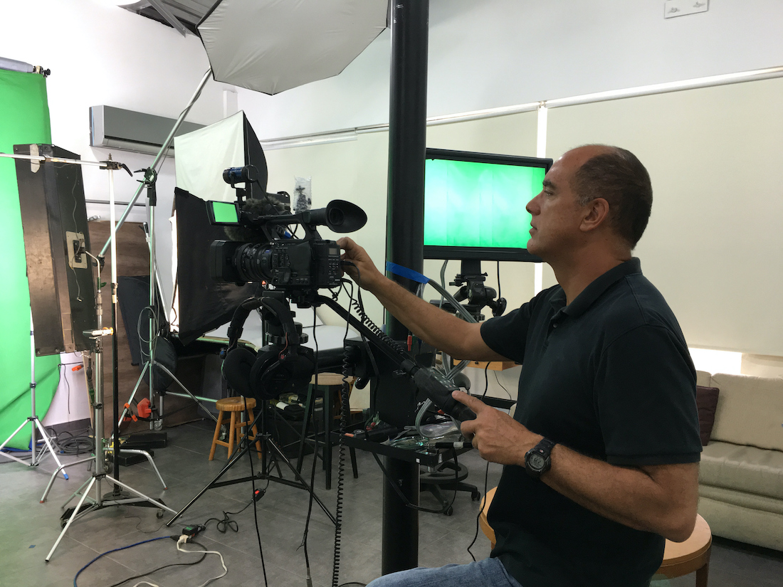 Videographer at work filming video in studio set.jpg