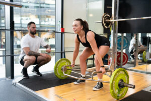 Male trainer at Fit Collective training a female client