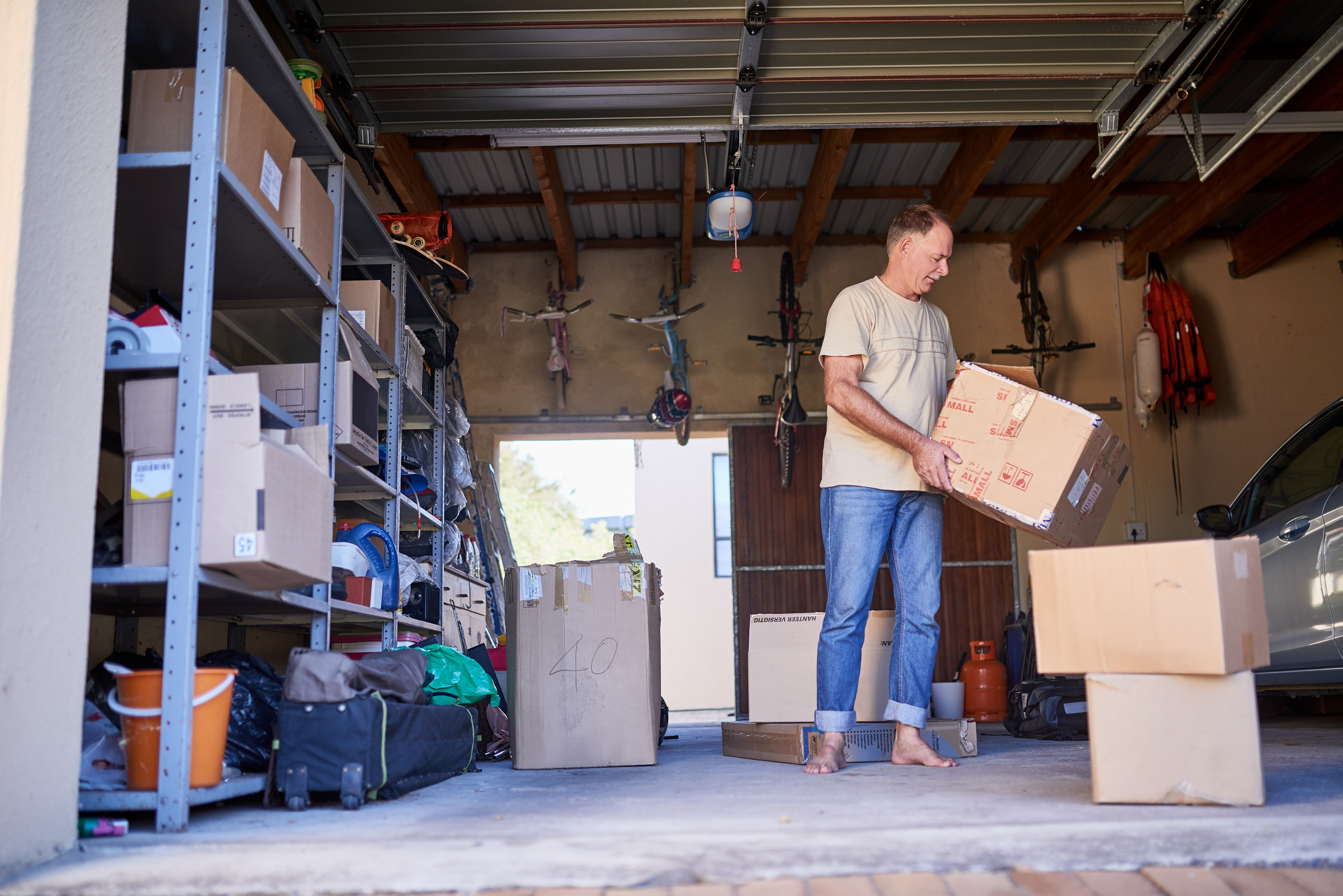 man carrying a box in a garage