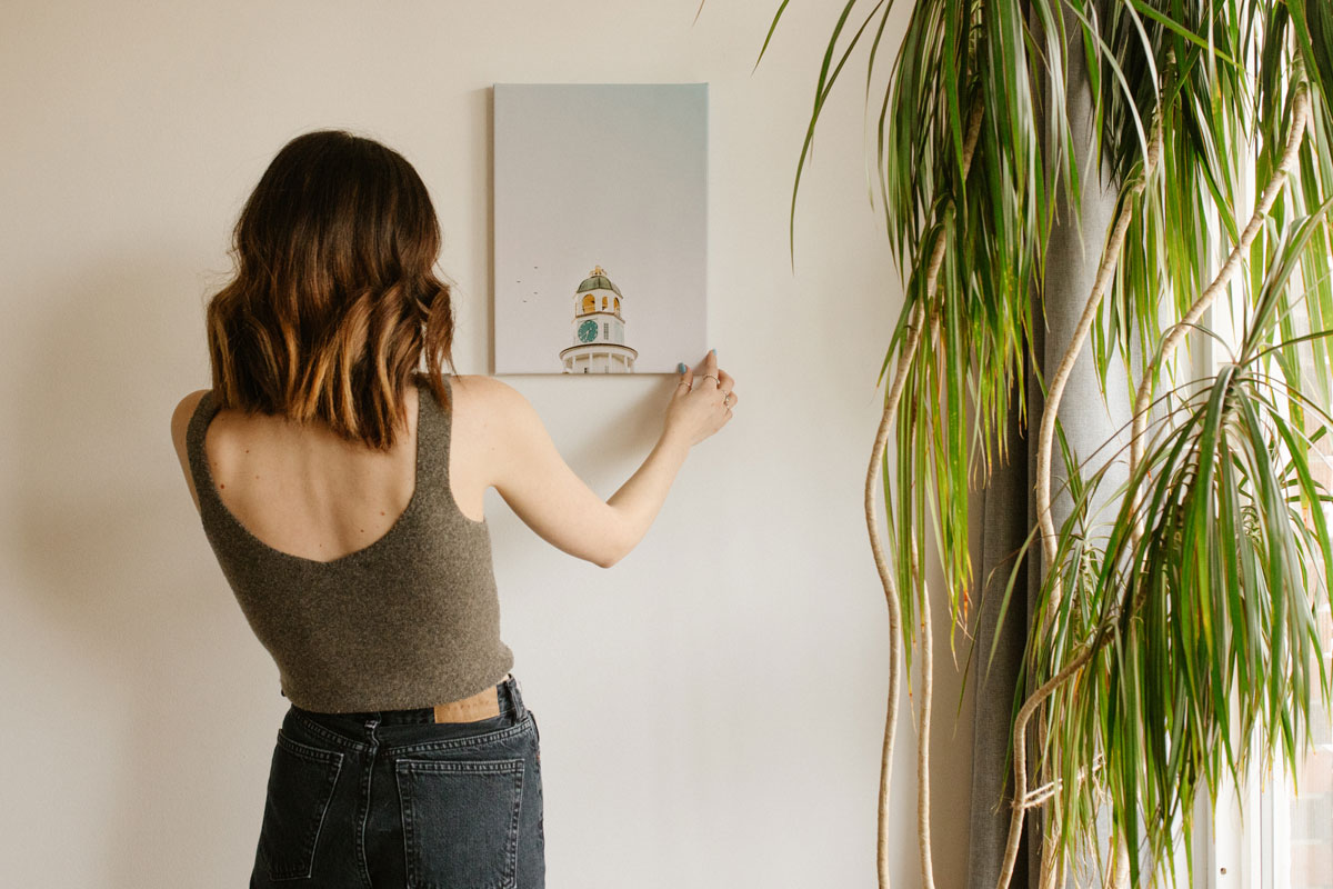 Photo of woman hanging print