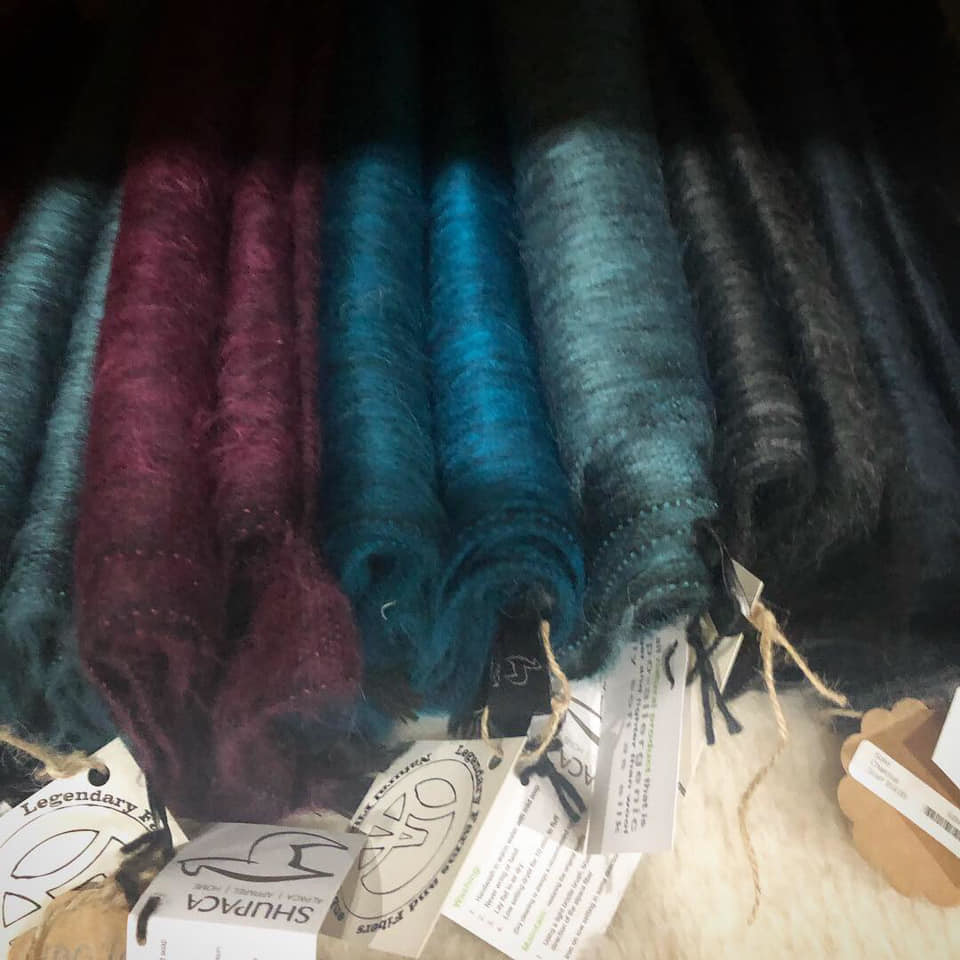 A series of colorful material wraps are made of alpaca fiber.
